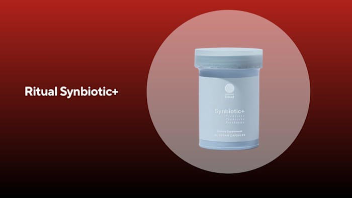 A light blue bottle of ritual synbiotic+ probiotics against a red background